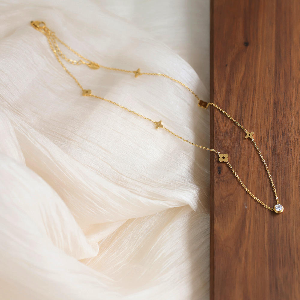 Gold-Tone Necklace with Polished Floral Motifs and Center Crystal Accent