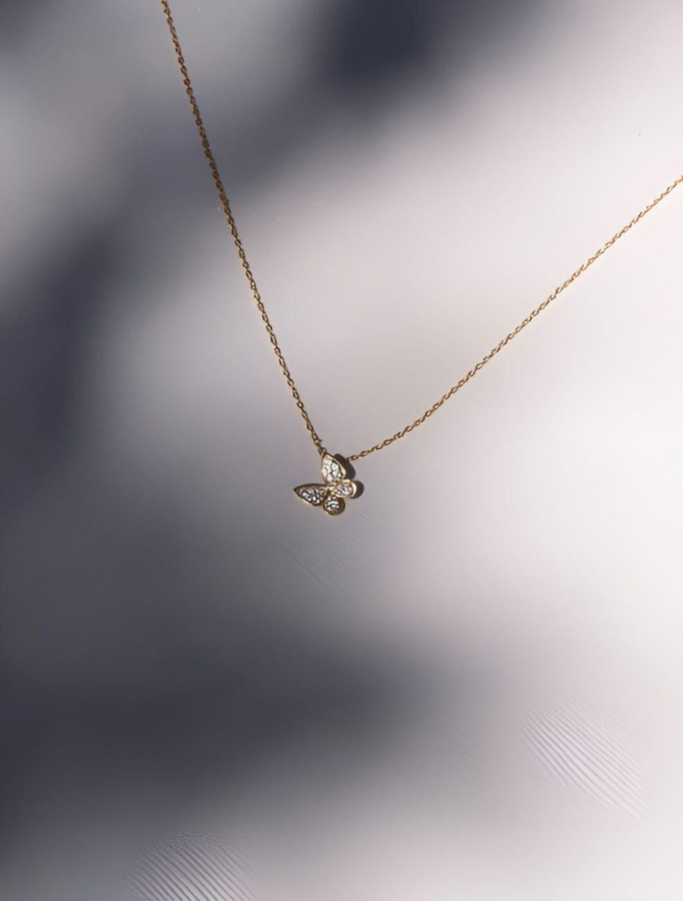 Gold-Toned Necklace with Crystal-Studded Butterfly Pendant