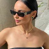 Gold Stud Earrings with Black Oval Center and Geometric Frame