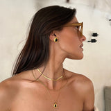 Gold Stud Earrings with Black Oval Center and Geometric Frame