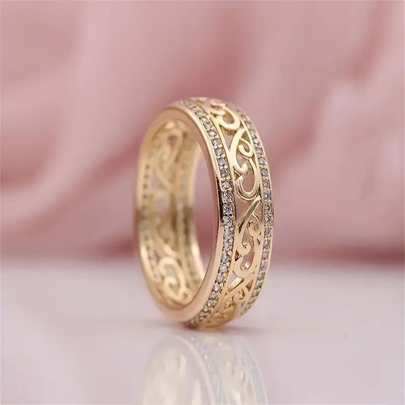Intricate Gold Band Ring with Filigree and Gemstone Detail