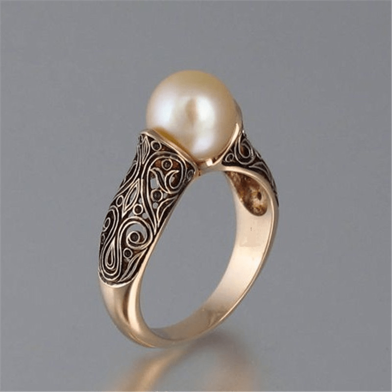 Polished Gold Ring with Decorative Pearl Setting