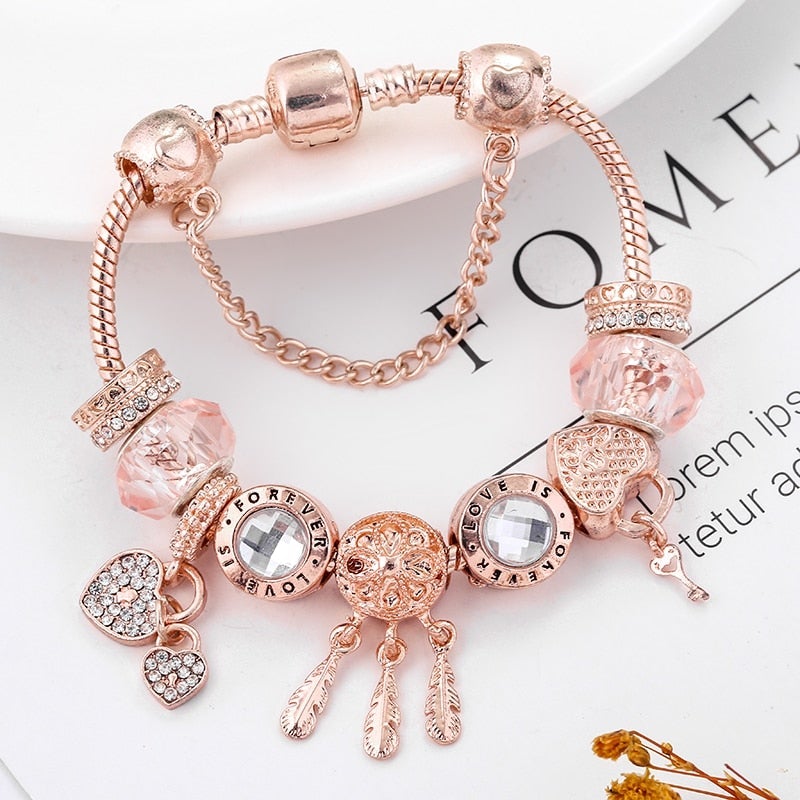 Rose-Tone Charm Bracelet with Beads and Dangling Accents